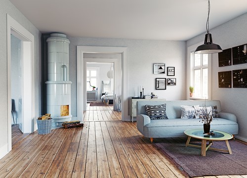 An livingroom view with furniture in Scandinavian style with wooden floors and bright lights.