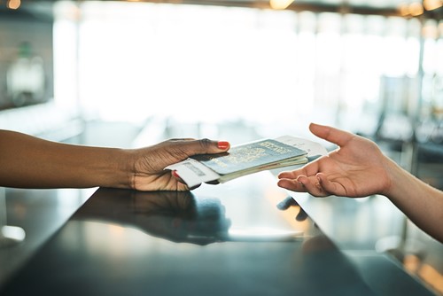 Two people exchanging immigration documentation when moving to another country.