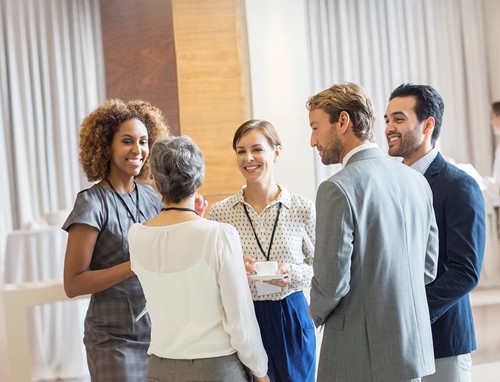 A group of business people from the Nordics discussing relocation services provider.